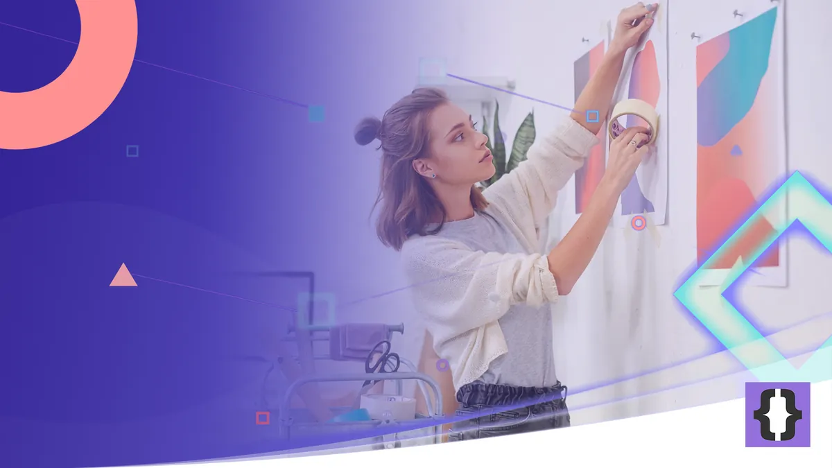 Portada del artículo «Tendencias de diseño gráfico que sí cambian el trabajo» de OverFuture, sobre una imagen de una diseñadora que cuelga carteles abstractos de colores en la pared de un estudio